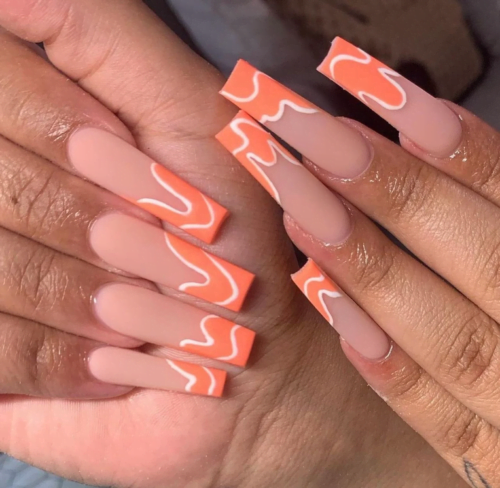 Long nude coffin nails with orange and white swirl tips