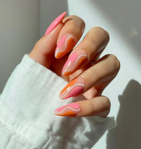 Pink and orange swirls nails in an almond shape