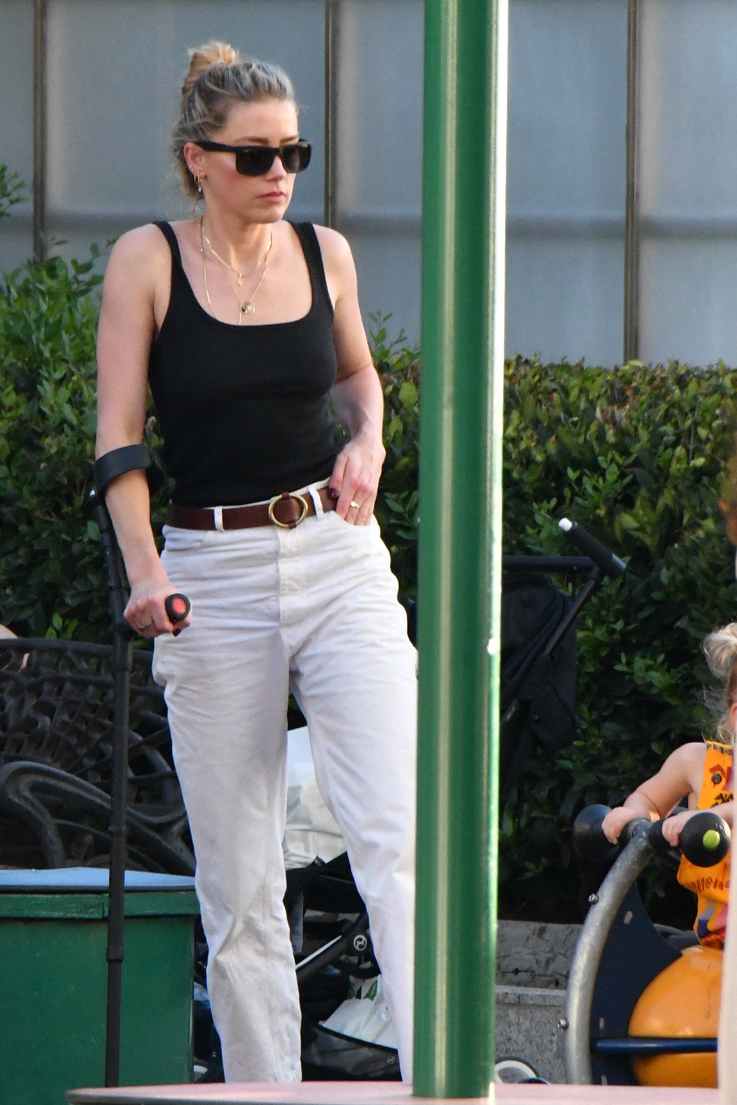 Amber Heard walking with a crutch