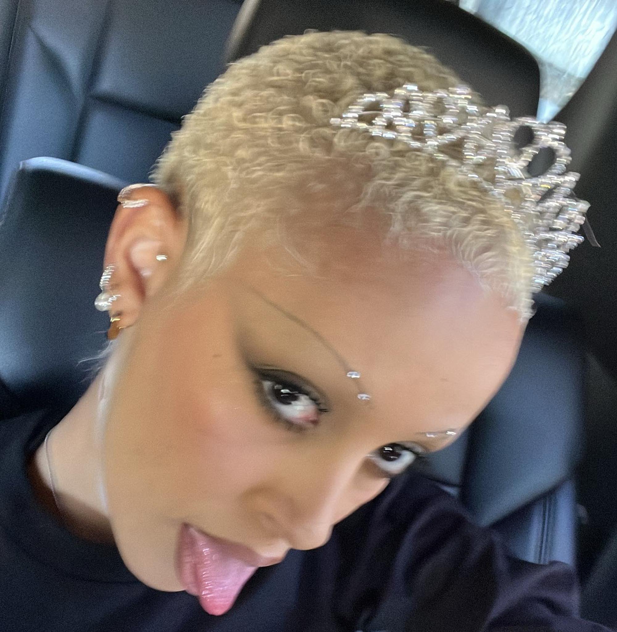 A selfie of Doja Cat with her tongue out.