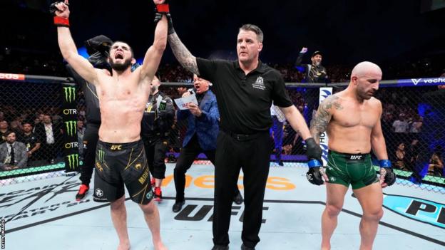Islam Makhachev gets his arm raised after beating Alexander Volkanovski in February
