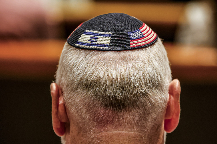 A closeup of a kippah showing the flags of Israel and the United States.