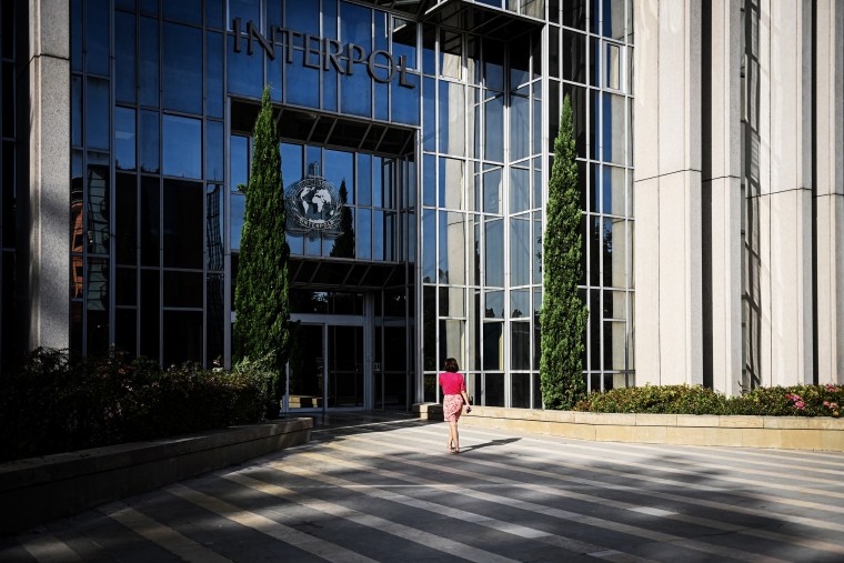 A woman walks towards the entrance of the International Criminal Police Organization headquarters, known as Interpol, in Lyon,France on Sept. 5, 2023.