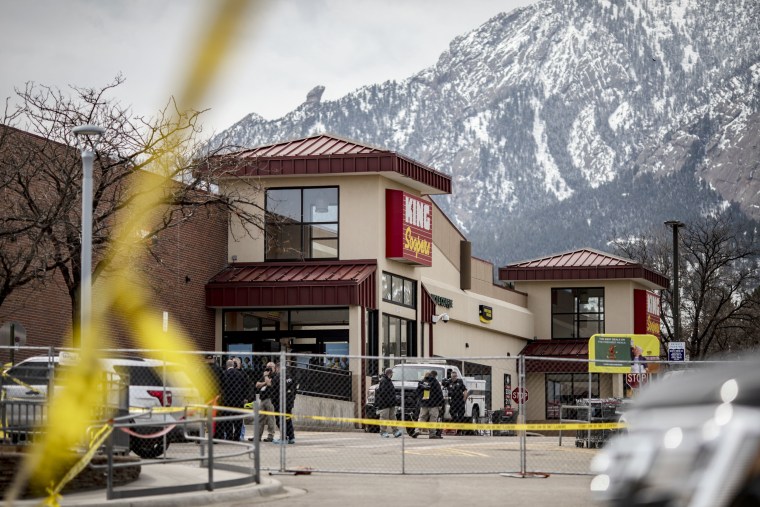 Police tape lines the site of a shooting at a King Soopers grocery store