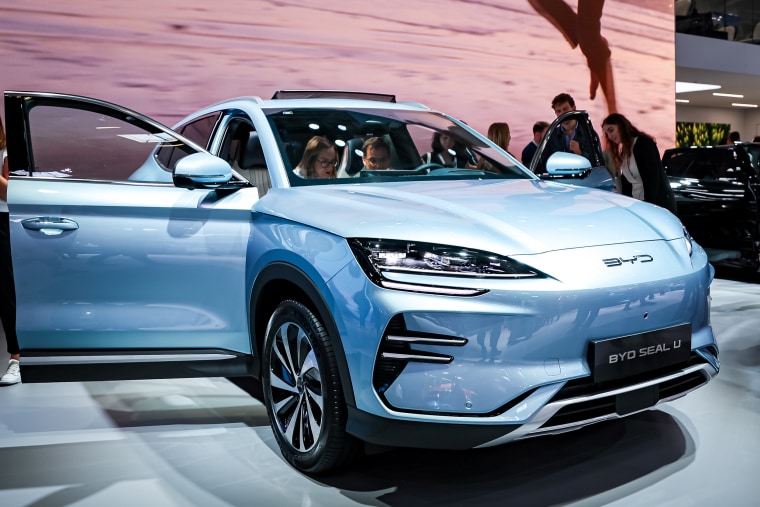 Visitors look at a BYD Seal U electric car at the IAA Mobility 2023 international motor show in Munich